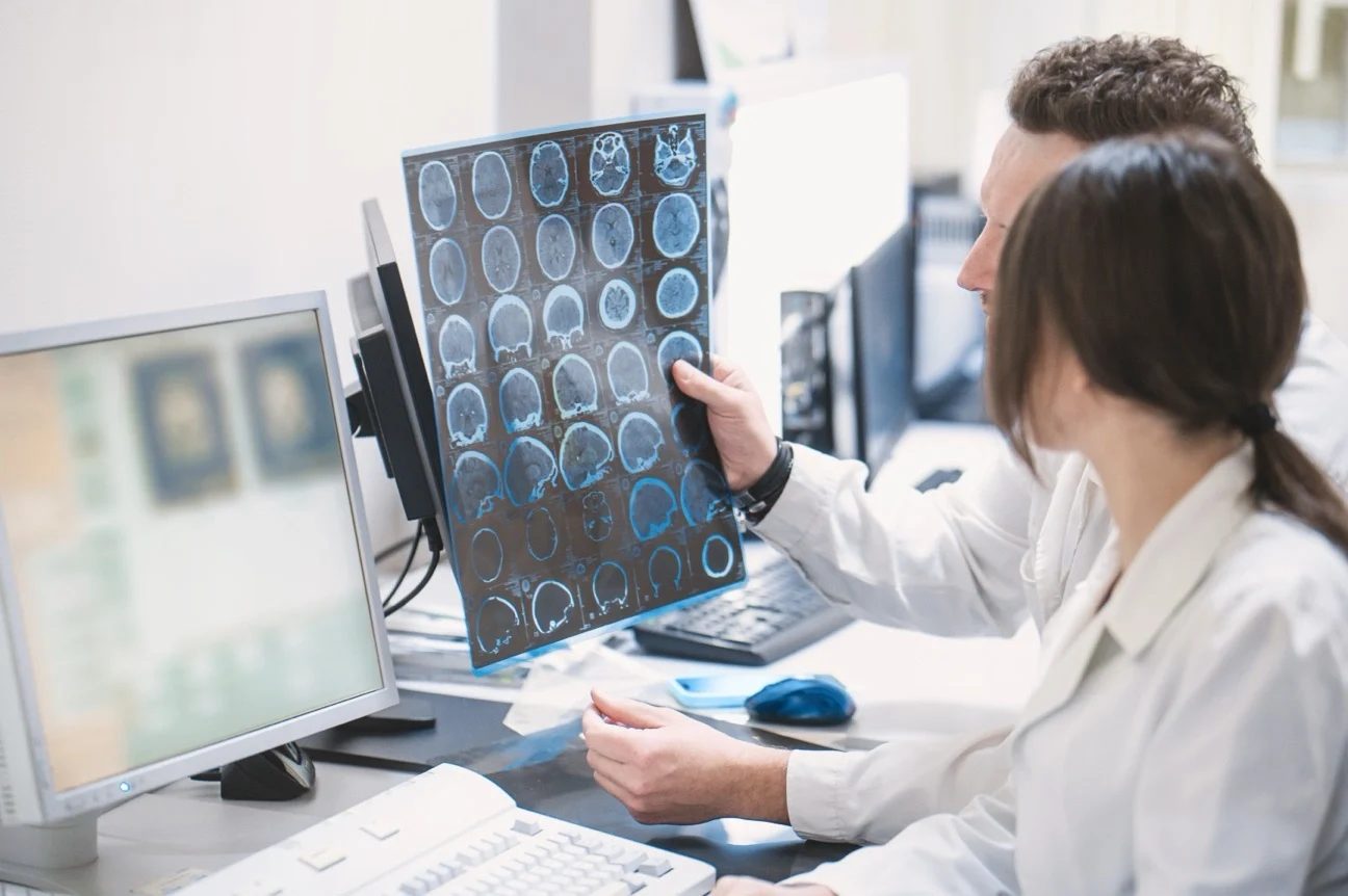 doctors looking over traumatic brain injury scan